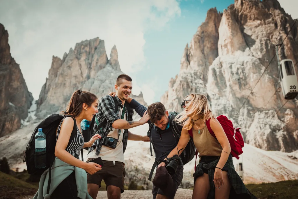 Friends laughing together on a mountain trip